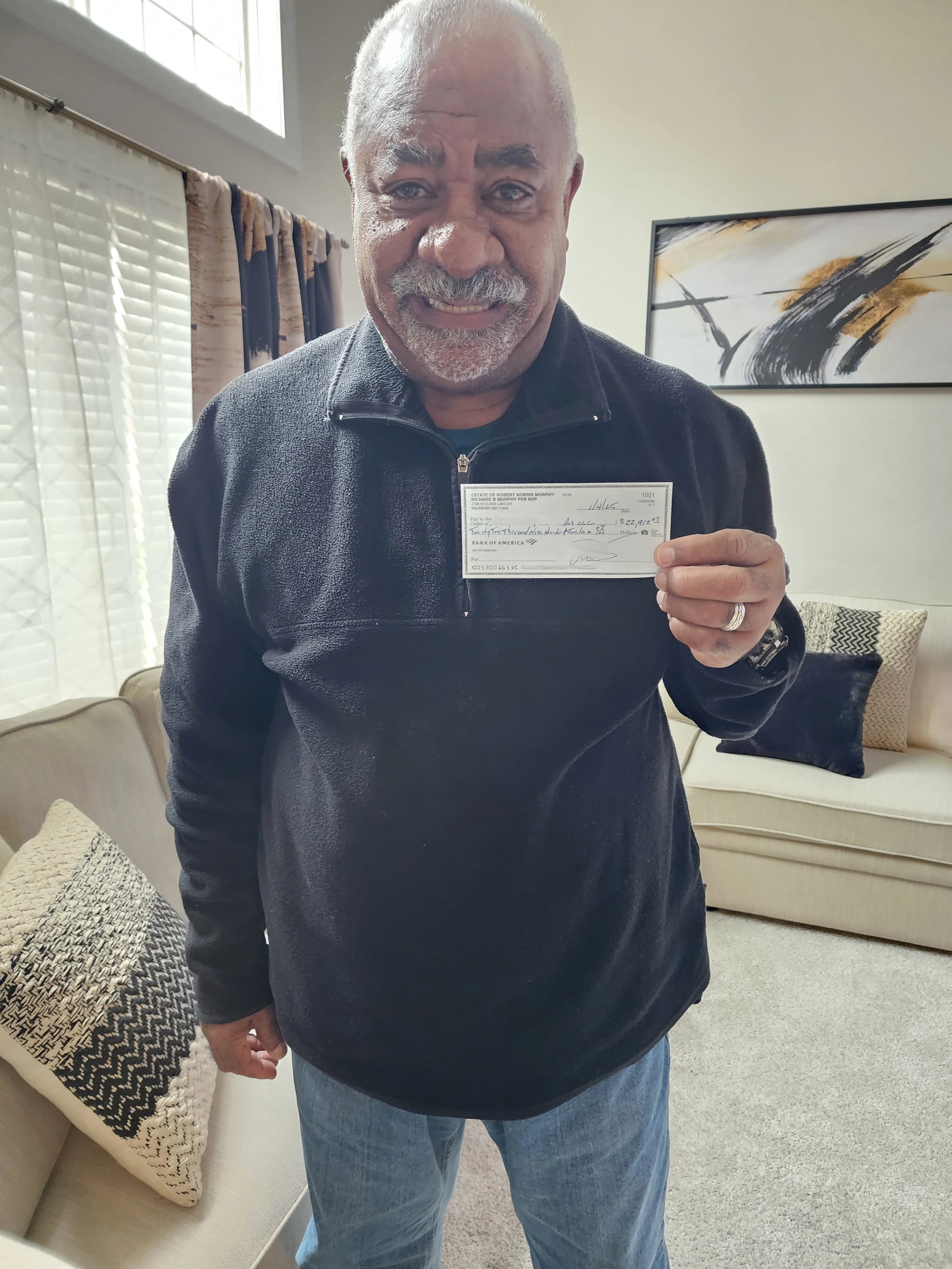 Carlos holding a check