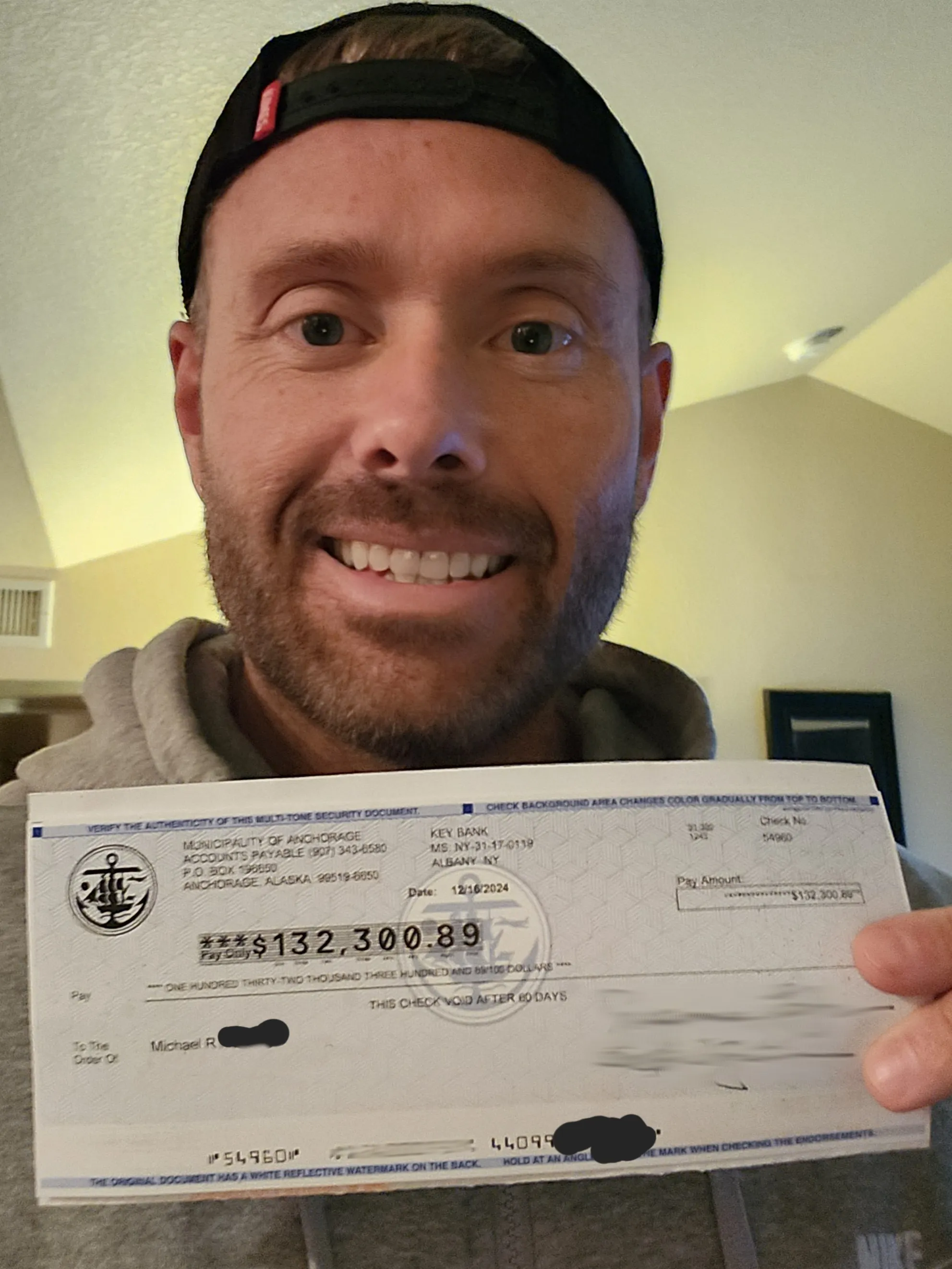 Danny holding a check