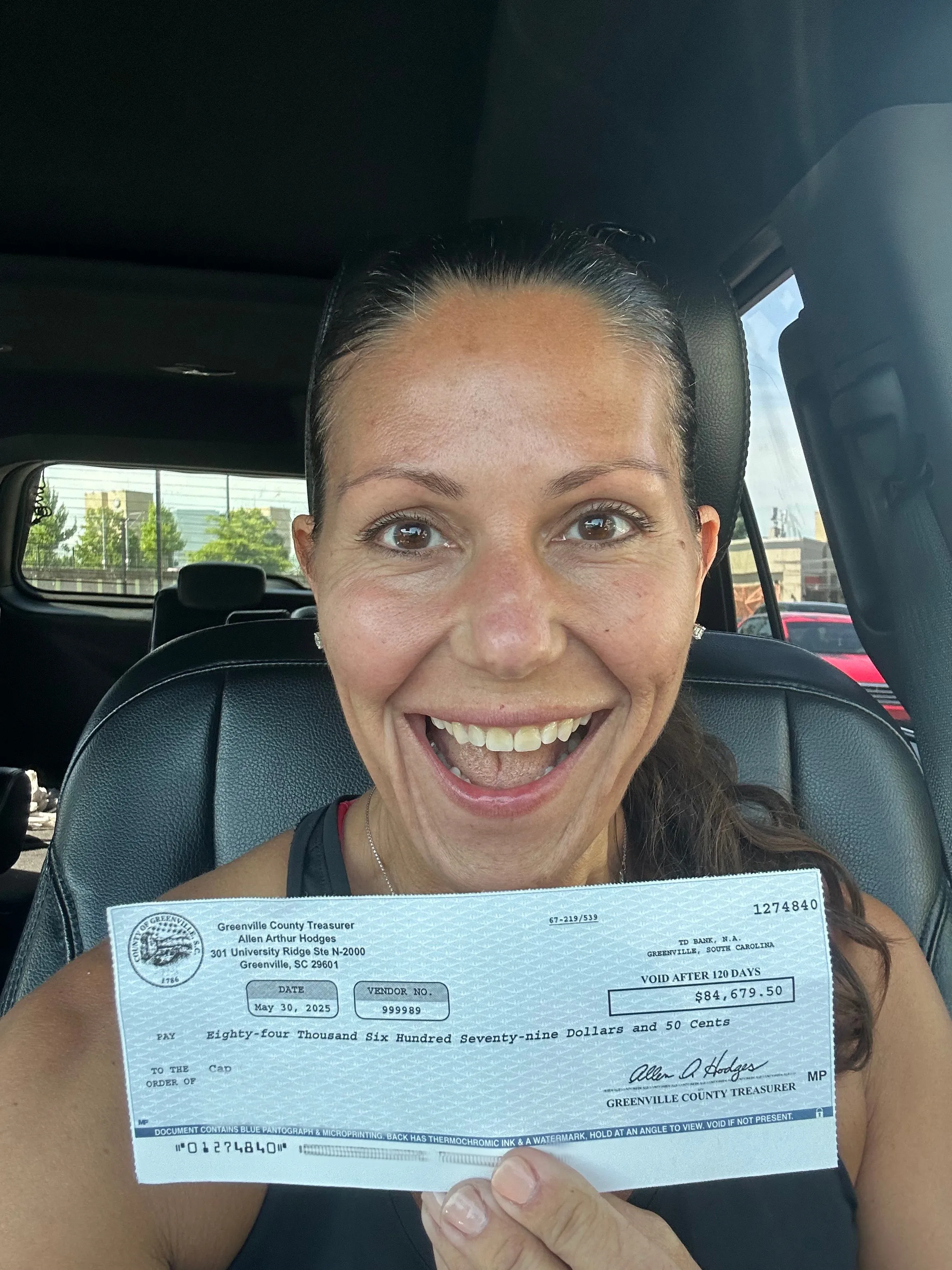 Halah holding a check