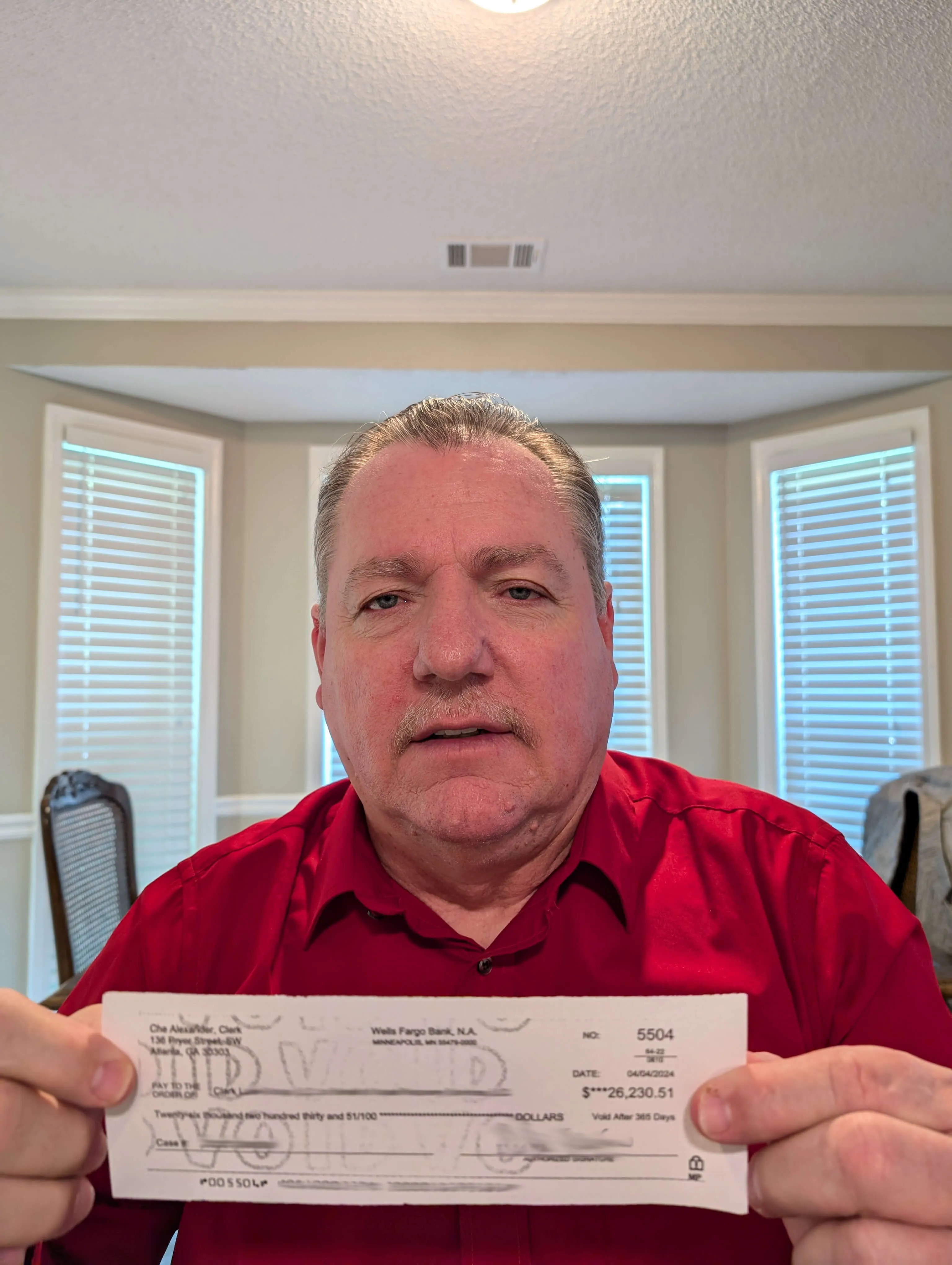 Richard holding a check